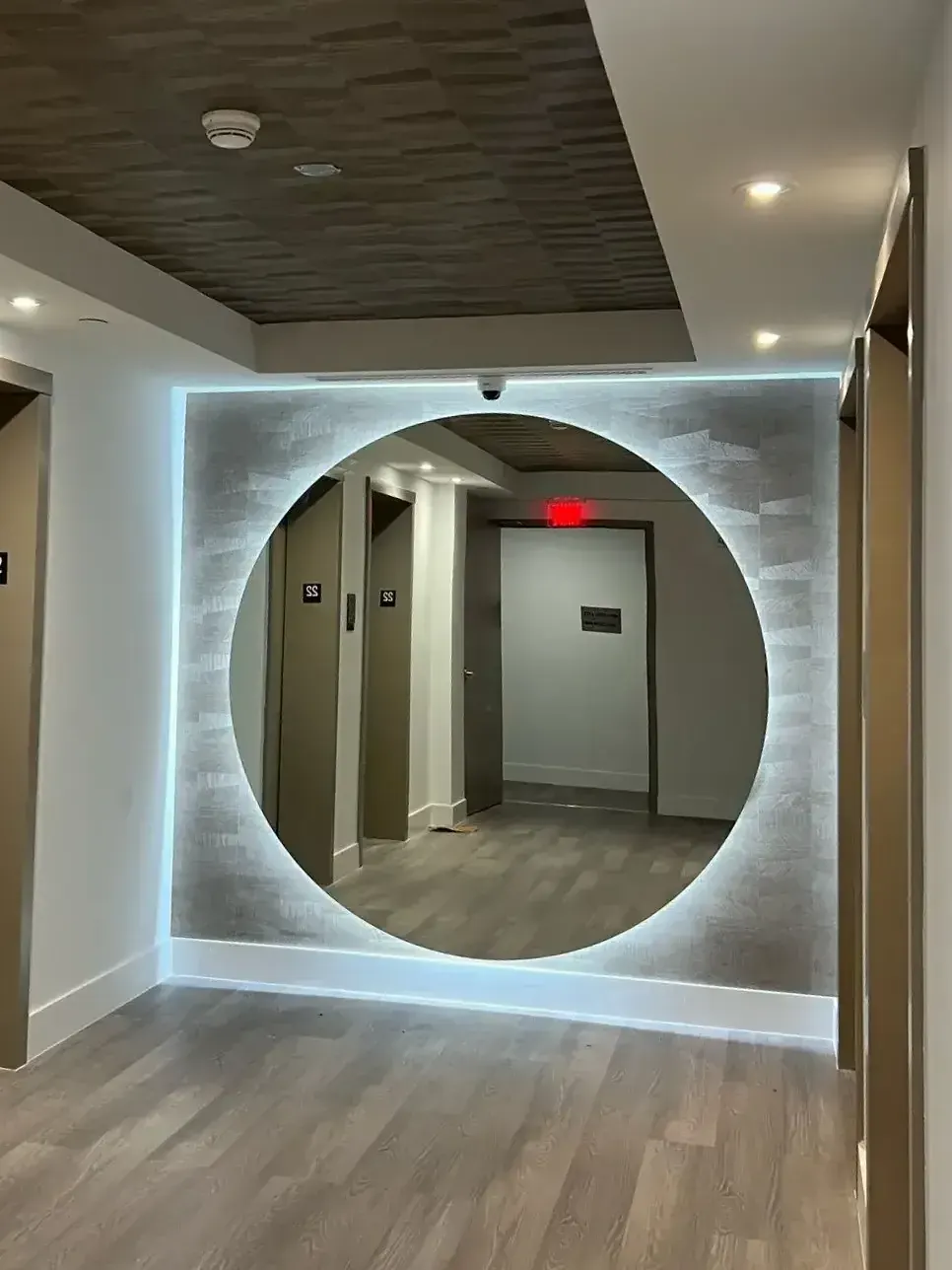 Elevator lobby with the new circular backlit mirror, Hollywood, FL